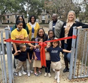  Students and teachers prepare to cut ribbon on new playground